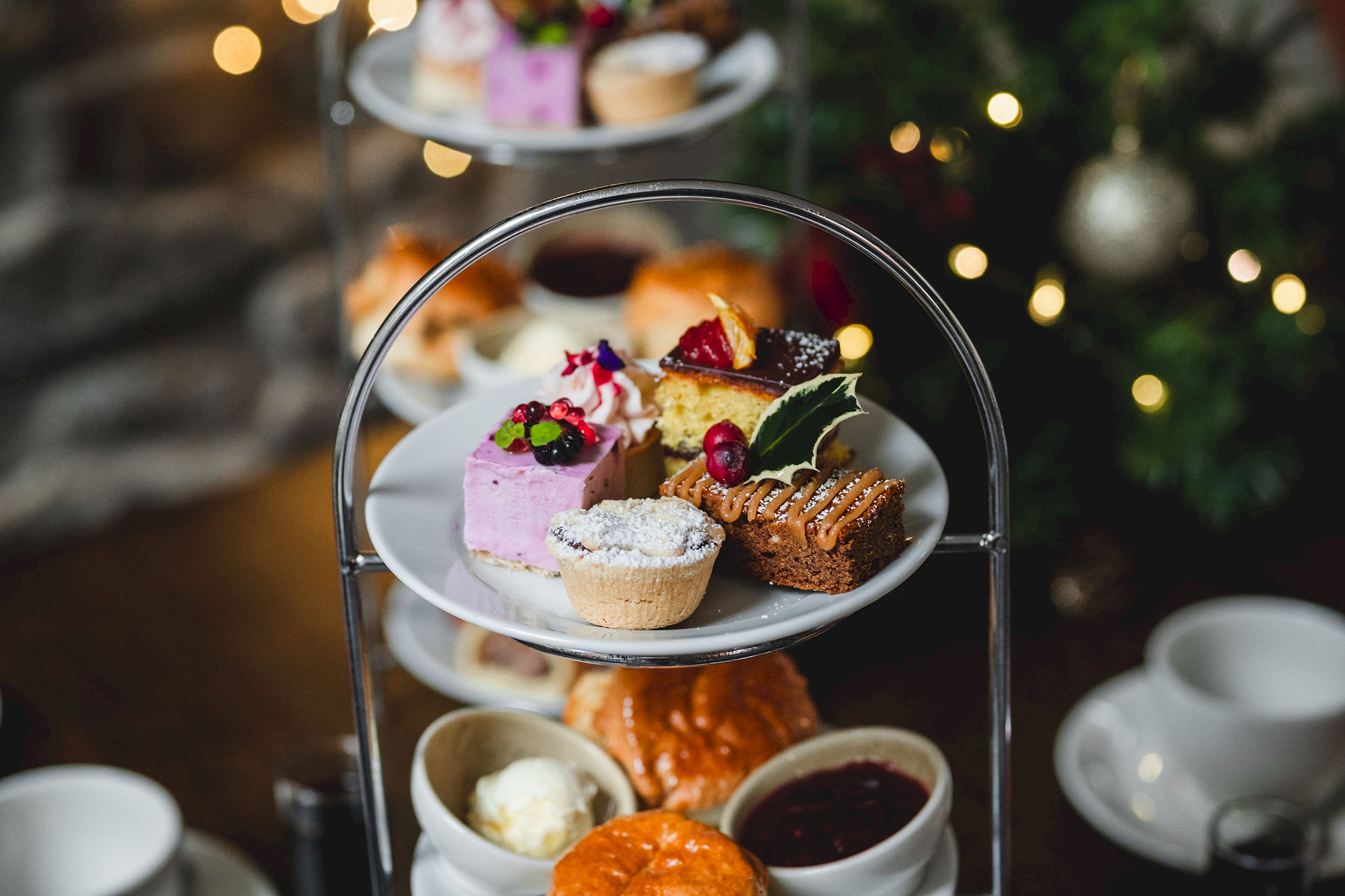 A selection of cakes and scones on a cake stand