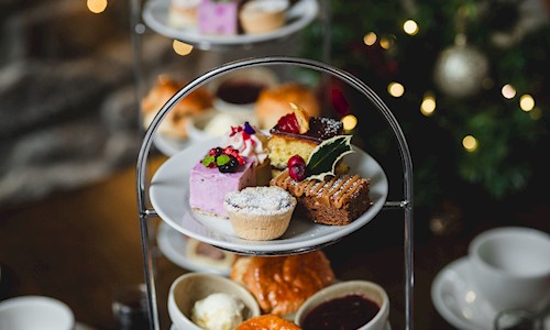 A selection of cakes and scones on a cake stand