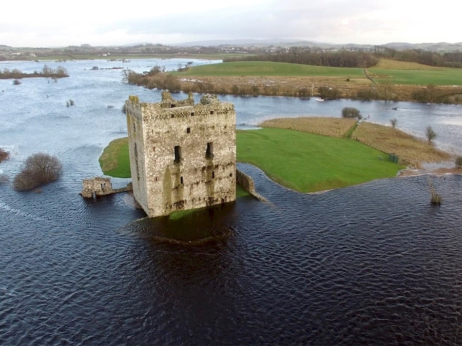 An aerial view of a castle surrounded by floodwater