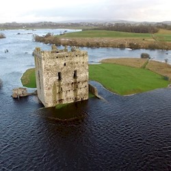 An aerial view of a castle surrounded by floodwater