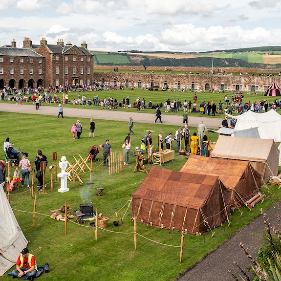 A living history camp dating back to Picts and Romans with lots of visitors milling around