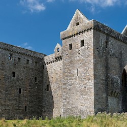 General view of Hermitage Castle with blue skies above
