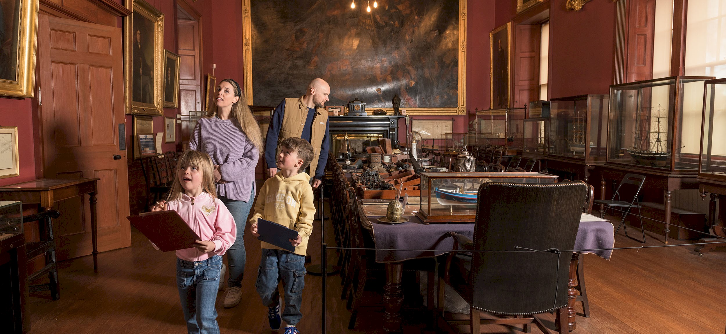 A family enjoying looking round a room in Trinity House
