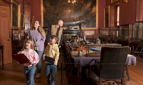 A family enjoying looking round a room in Trinity House