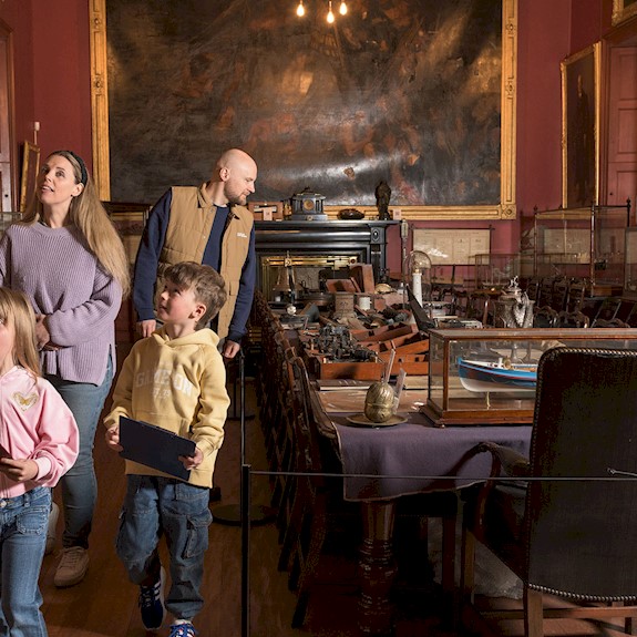 A family enjoying looking round a room in Trinity House