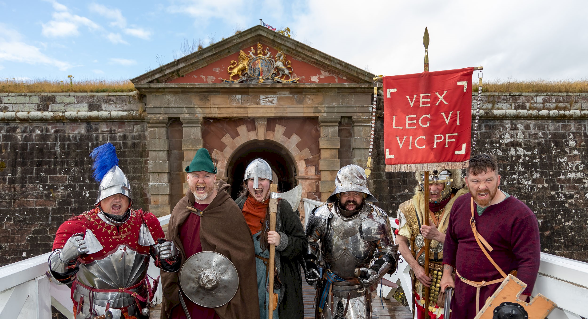 A group of re-enactors lined up and ready to defend a fortress