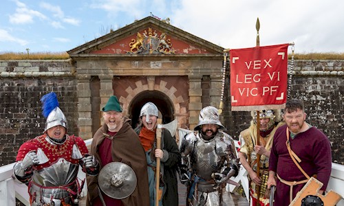 A group of re-enactors lined up and ready to defend a fortress