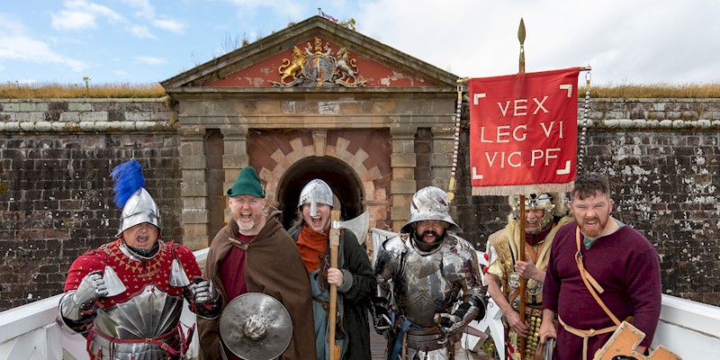 A group of re-enactors lined up and ready to defend a fortress