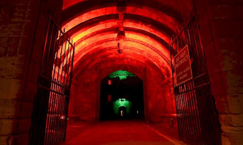 Linlithgow Palace entrance at night, floodlit with red and green