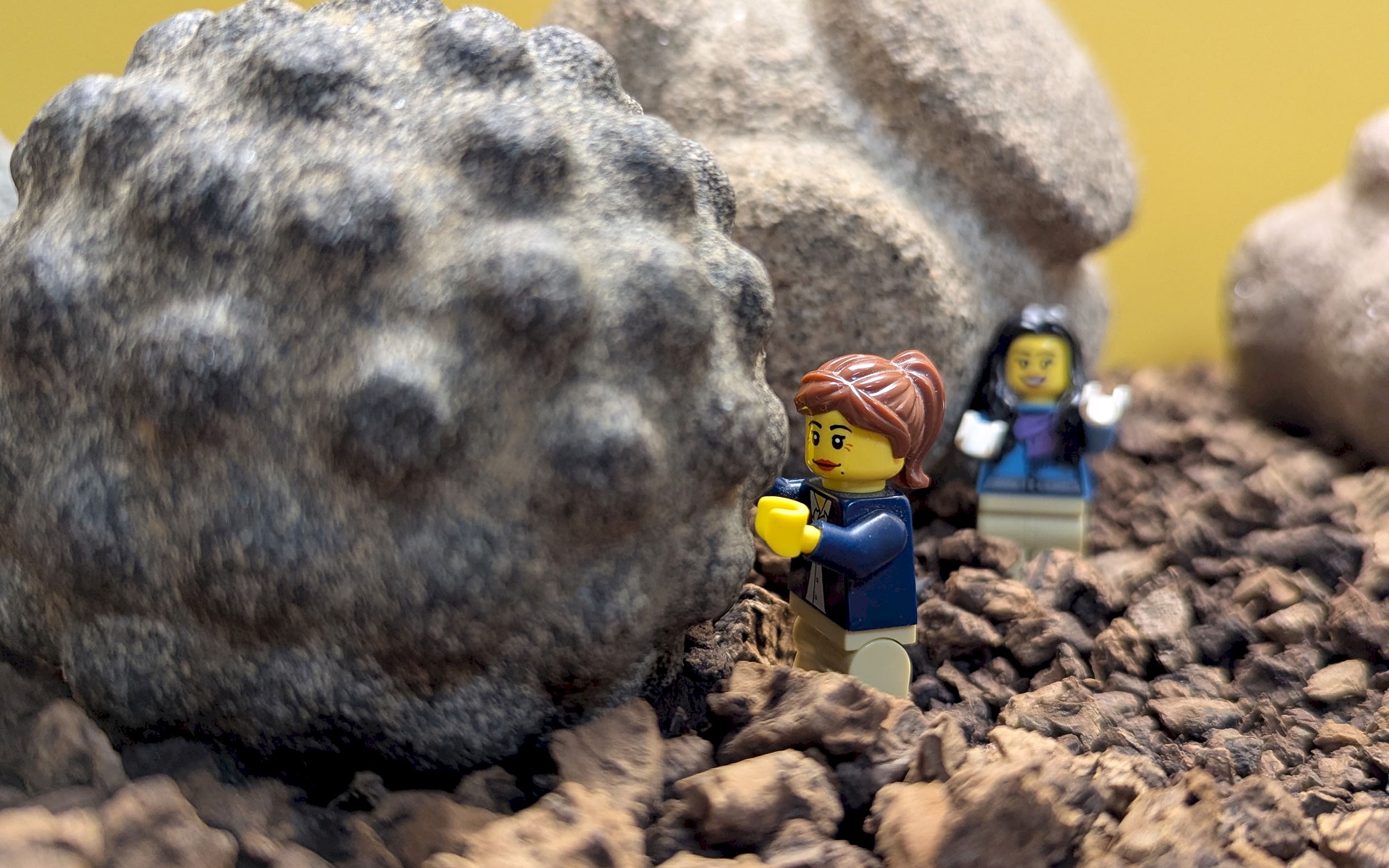 Two lego figures standing on rubble