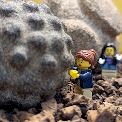 Two lego figures standing on rubble