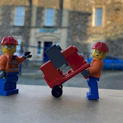 Lego figures in front of a tenement building