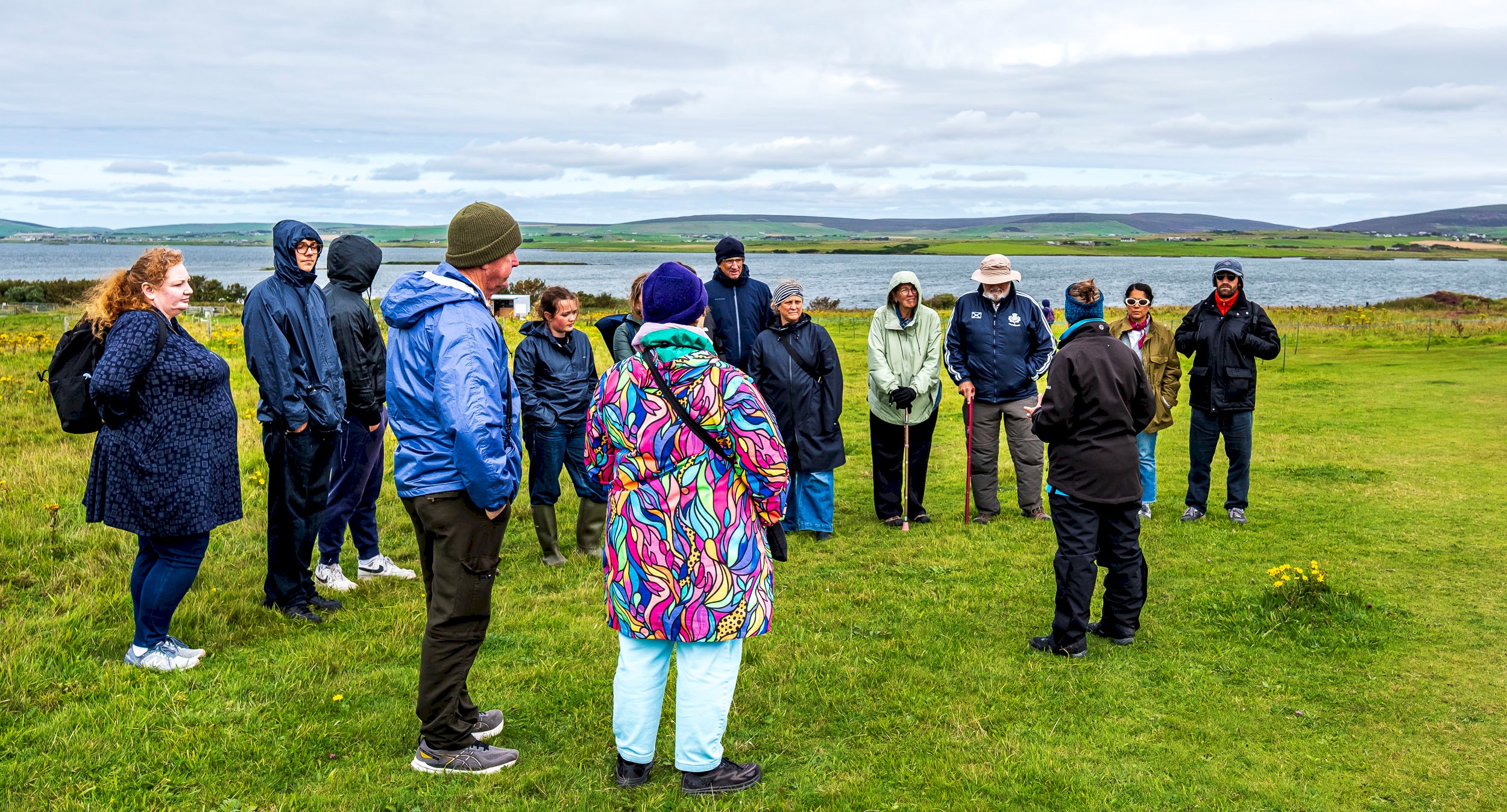 A group of people listening to a Ranger telling them about the area they are in