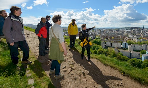 Group of people enjoying a tour of Arthur's Seat with one of our Rangers