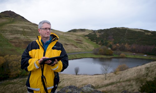 Portrait of Aerial Survey Projects Manager; Dave Cowley, in Holyrood Park