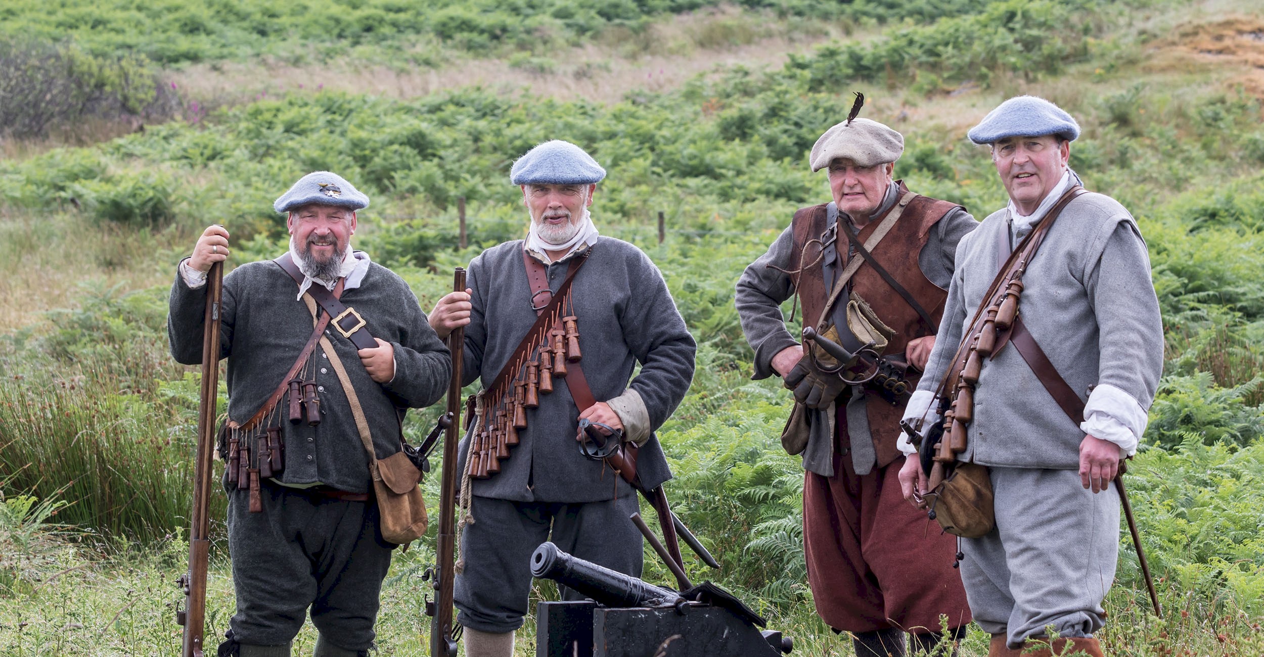 Four people dressed as soldiers ready for battle