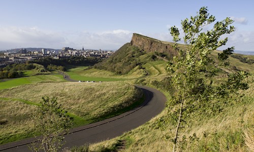 View of Salisbury Crags from the High Road with Edinburgh Castle in the background 