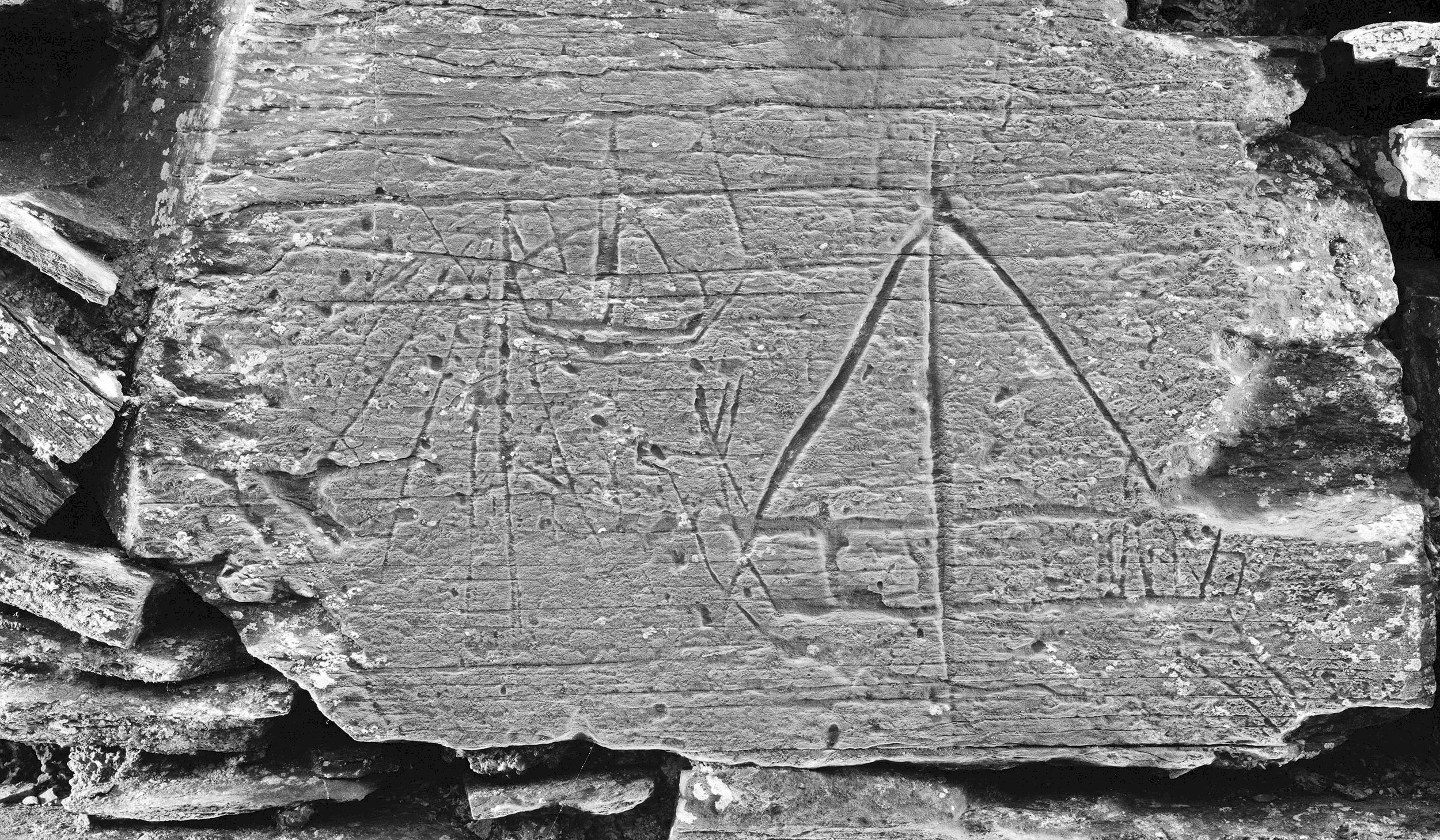 A stone with a boat carved on it