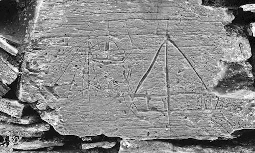 A stone with a boat carved on it