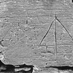 A stone with a boat carved on it