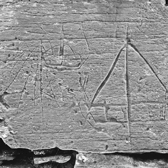 A stone with a boat carved on it