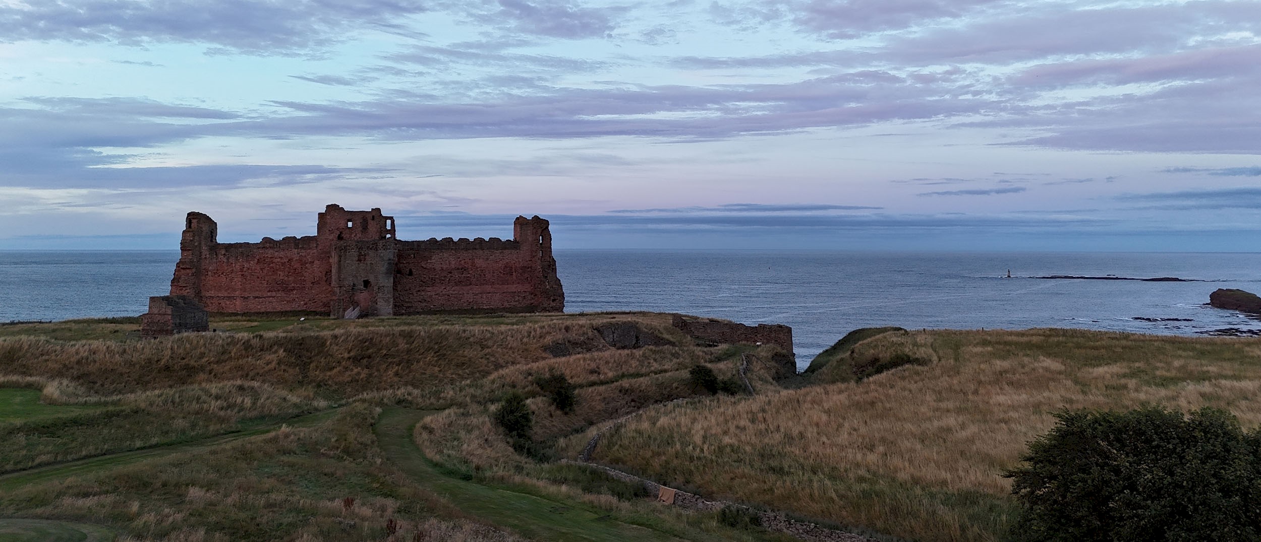 View of a castle with the a blue/red sky above