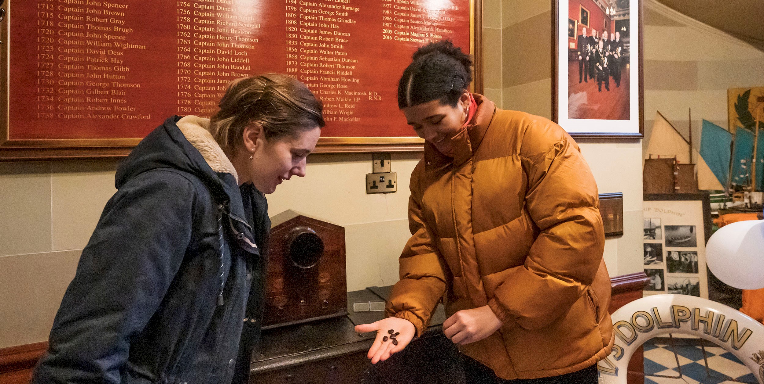 Two people looking at an item in Trinity House