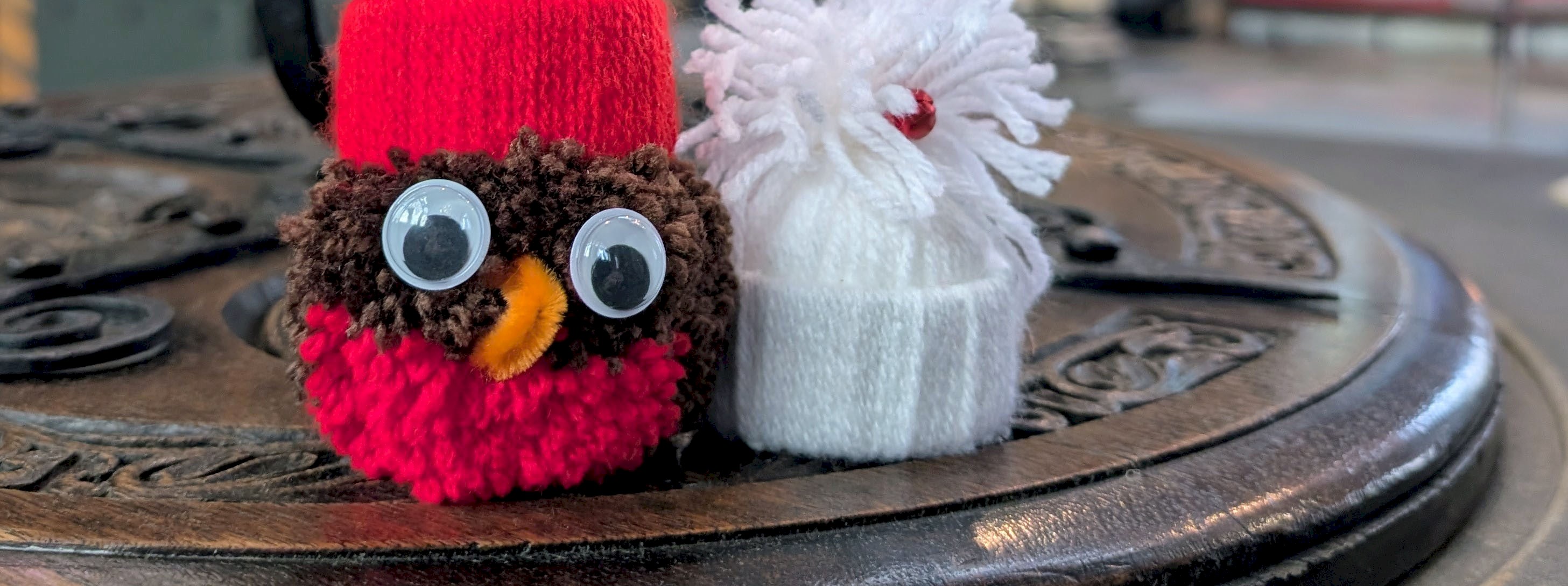 Two woolly Christmas tree decorations, a Robin and a santa hat 