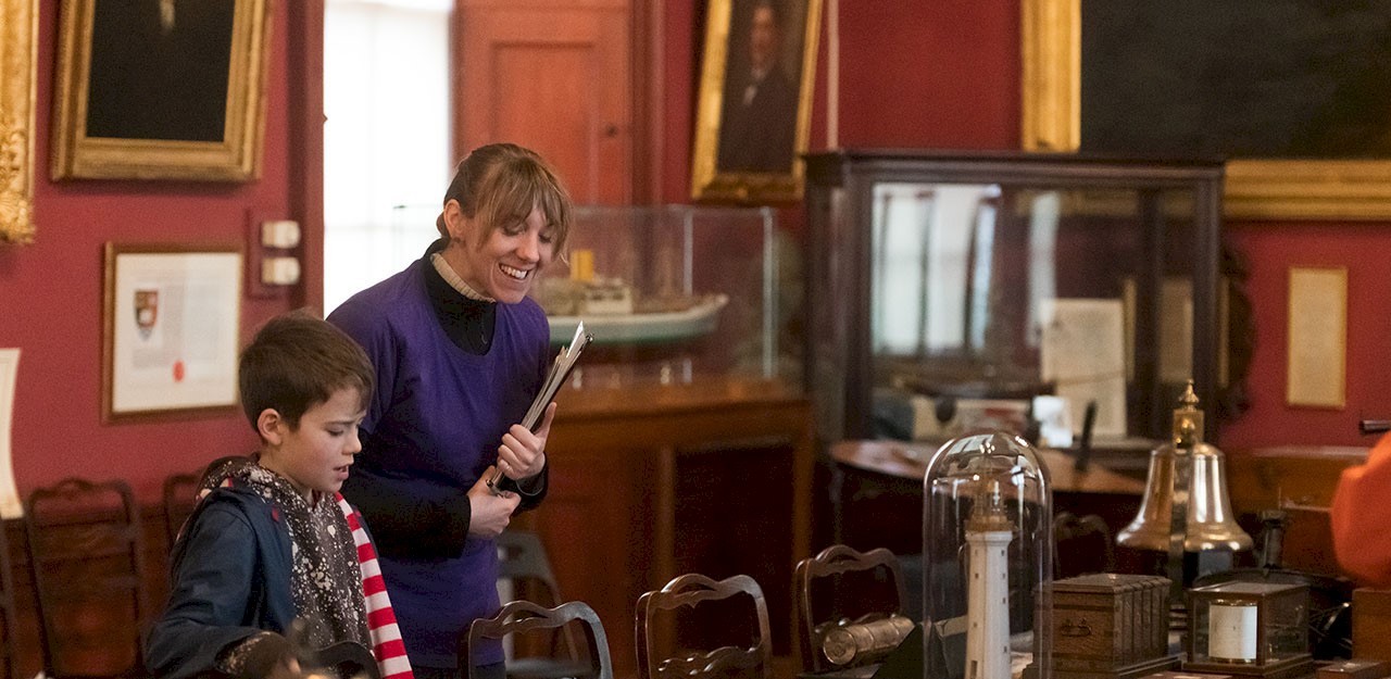 A woman and boy looking at maritime objects