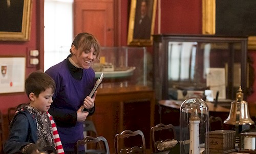 A woman and boy looking at maritime objects