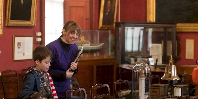 A woman and boy looking at maritime objects