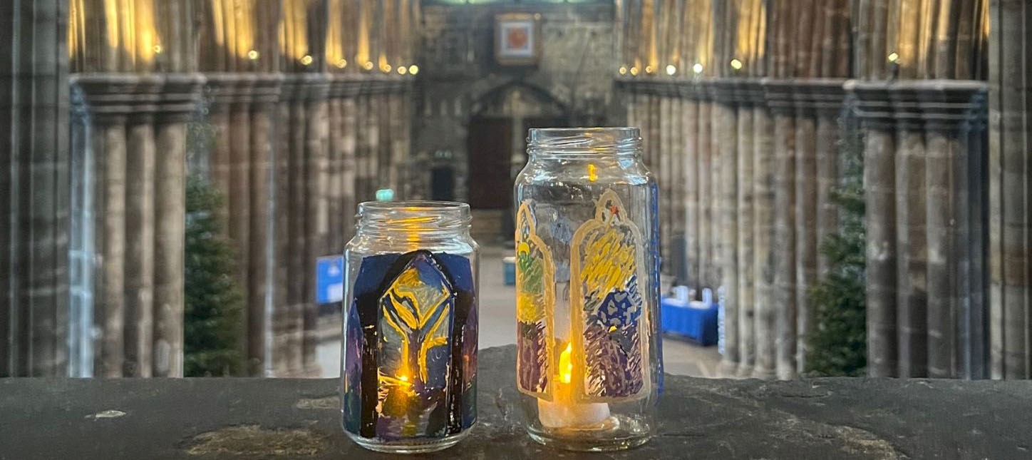 Decorated jars with candles inside in the nave of a cathedral