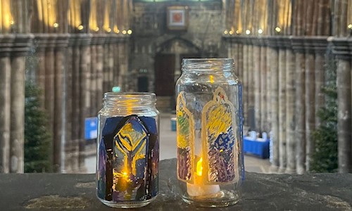 Decorated jars with candles inside in the nave of a cathedral
