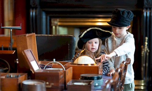 a boy and girl looking at objects in Trinity House