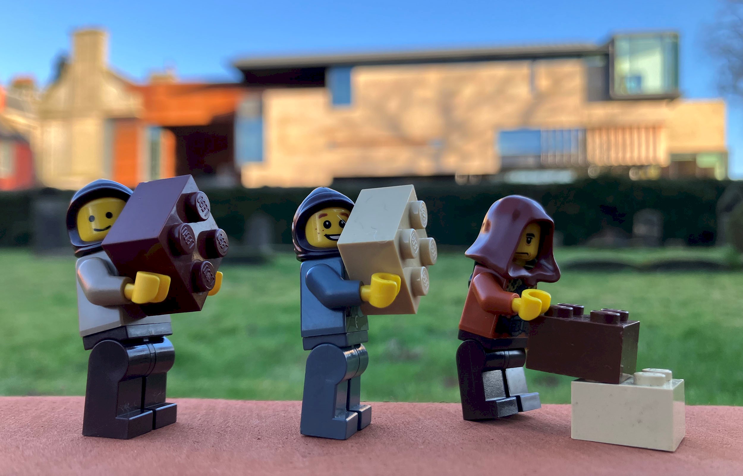 Three lego figures in the grounds of Dunfermline Carnegie Library & Galleries