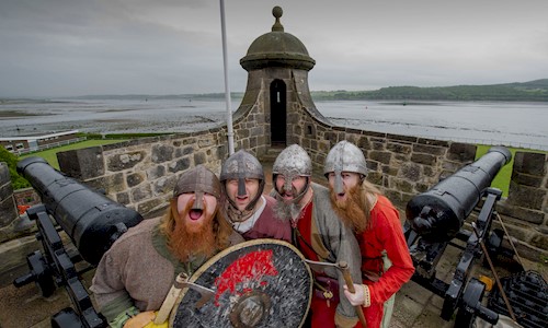 Costumed performers at Dumbarton Castle with Firth of Clyde in the background