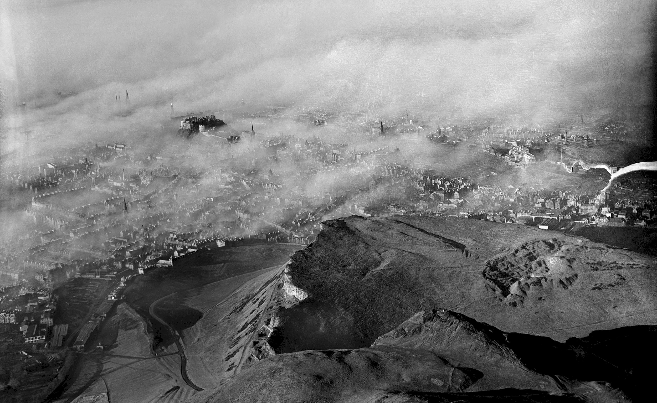 Black and white aerial image with views over Arthur's Seat and Edinburgh Castle 