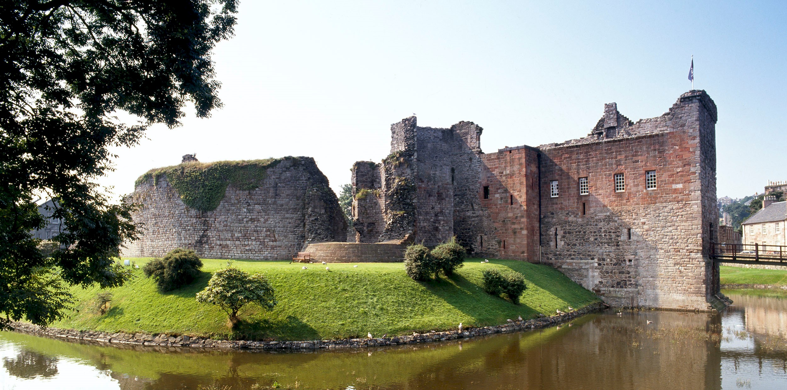 Exterior of a castle surrounded by a moat