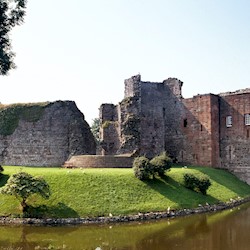 Exterior of a castle surrounded by a moat