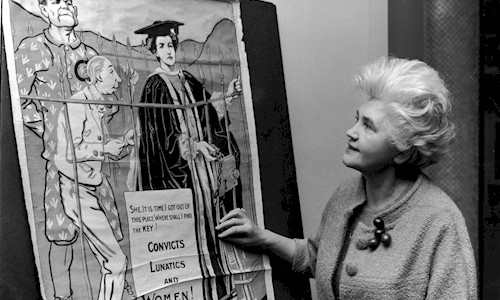 Labour MP looking at an pro-Suffragette poster at the opening of an exhibition on the Suffragetter Movement in February 1968