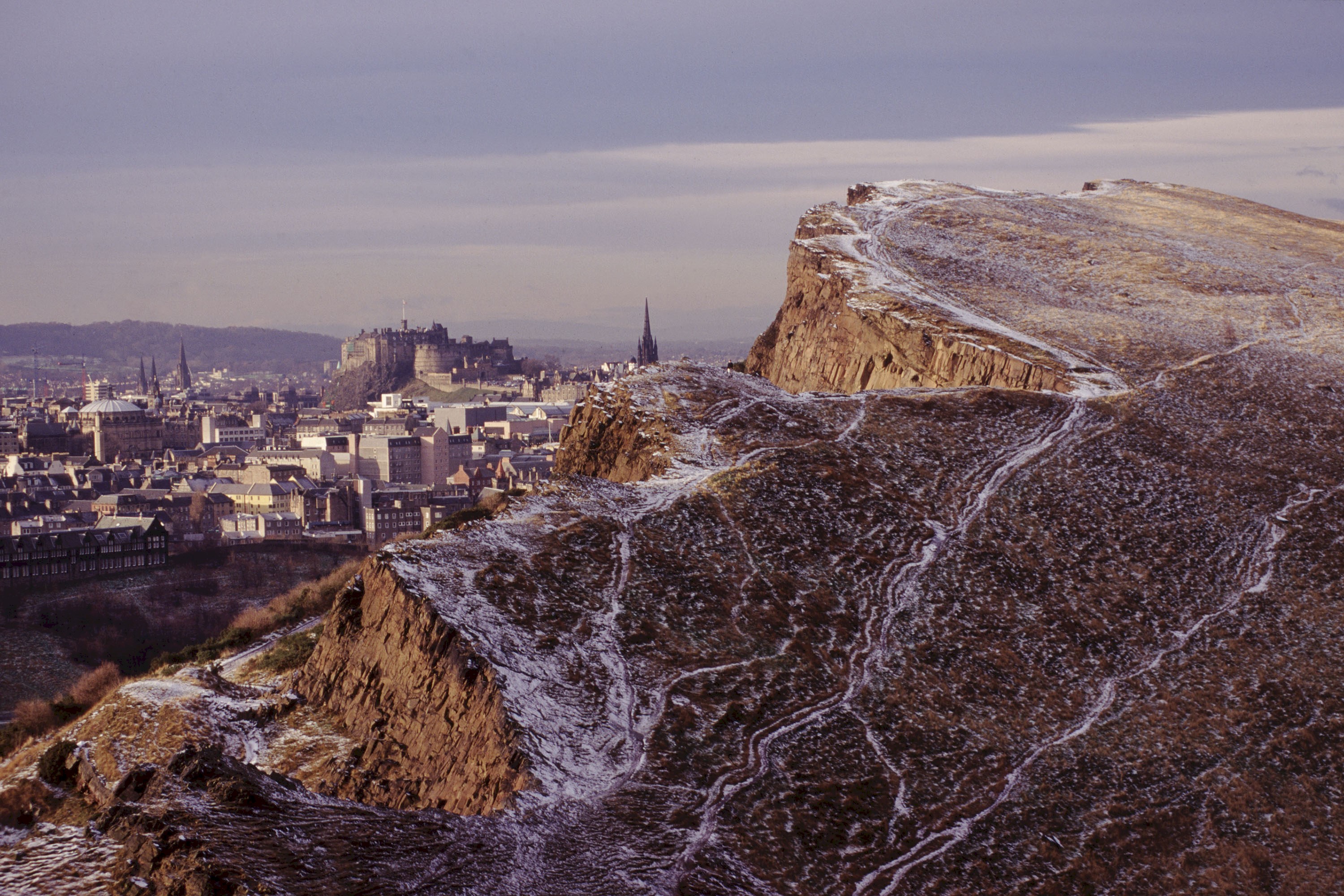 Salisbury Crags with light snow covering and Edinburgh Castle in the background