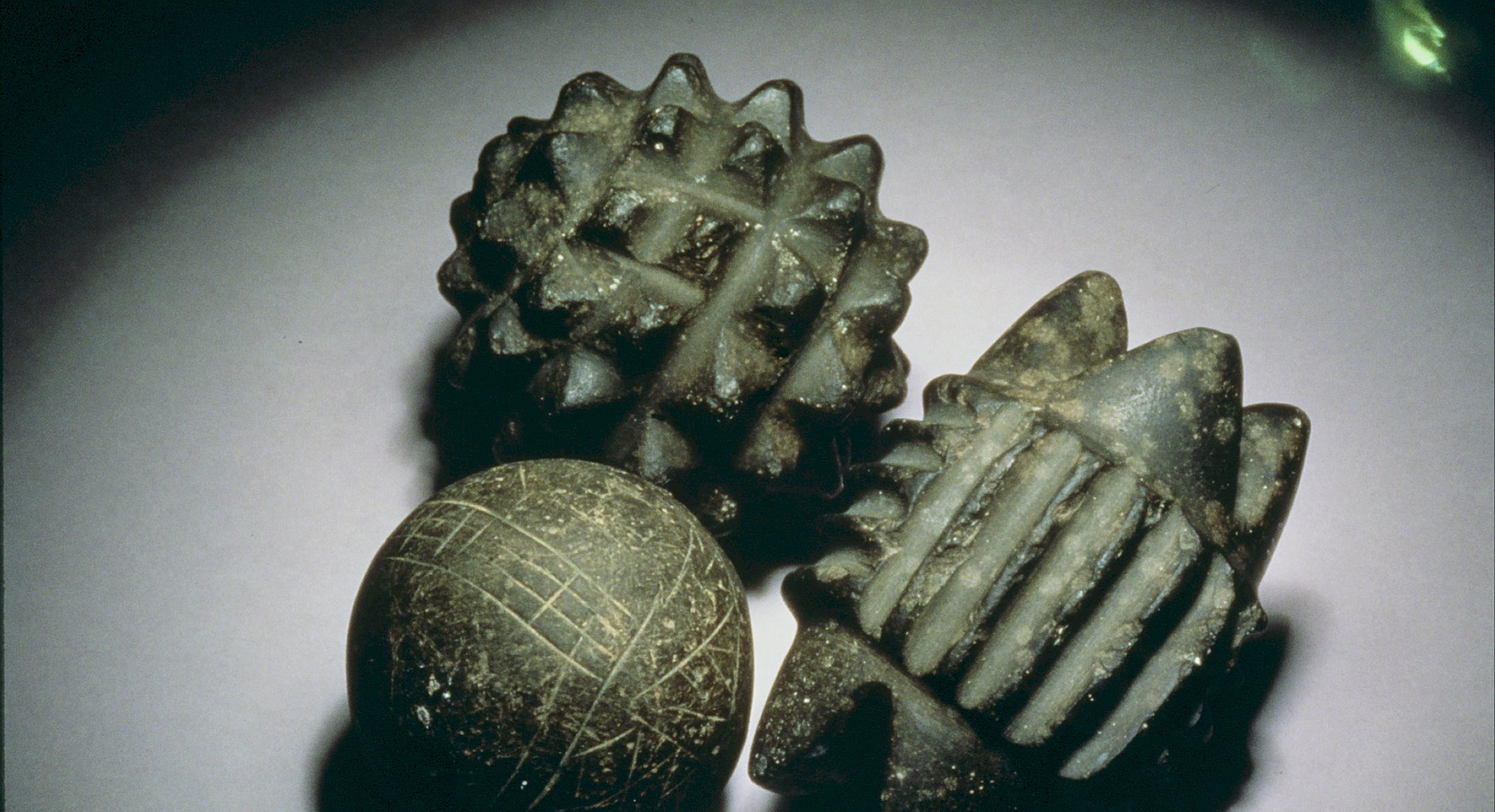 Three carved stone balls