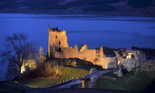 Loch Ness and Urquhart Castle on a dark night and floodlit