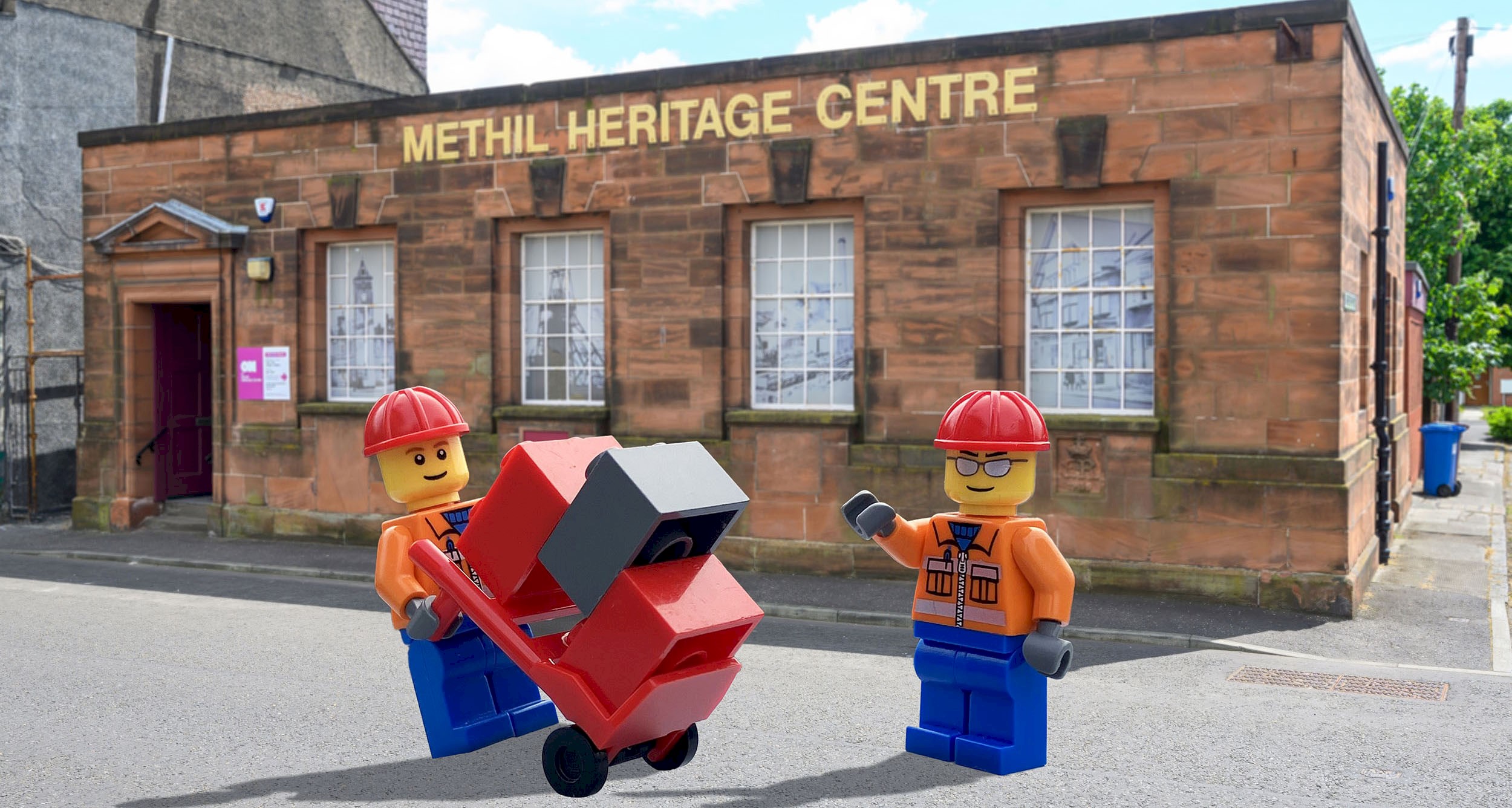 Two lego figures standing in-front of the Methil Heritage Centre