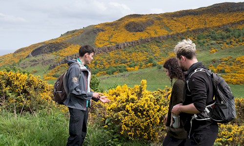 Park Ranger taking people on a tour round Holyrood Park