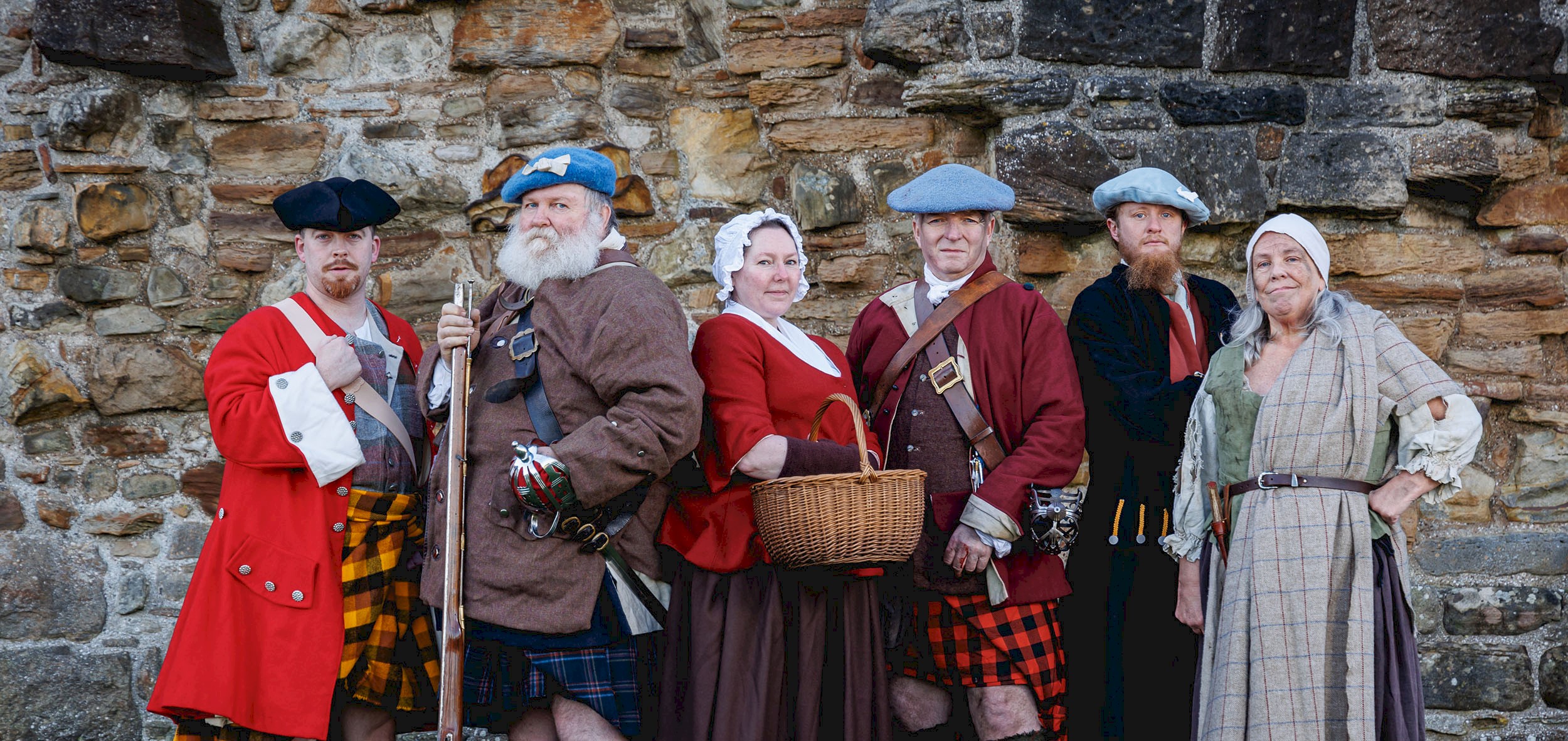 Six re-enactors in various historical costumes