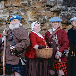 Six re-enactors in various historical costumes