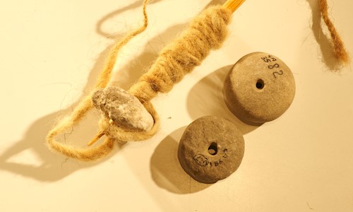 Two stone spindle whorls