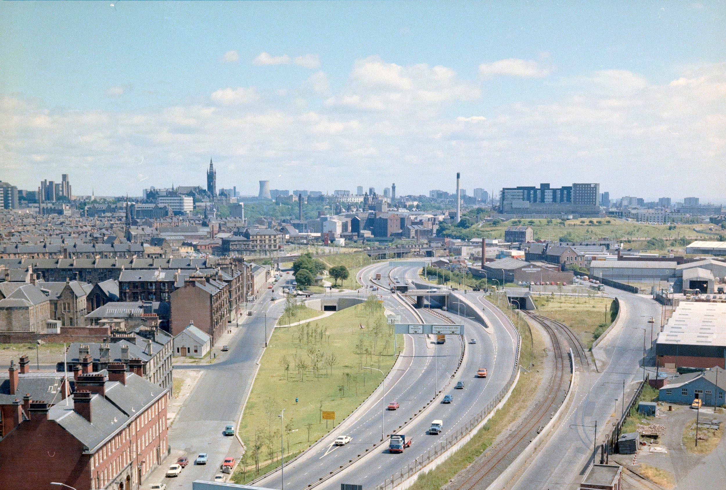 A view of a motorway with buildings surrounding