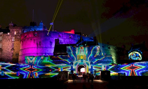 Exterior of Edinburgh Castle with lots of colour and pattern being projected onto it